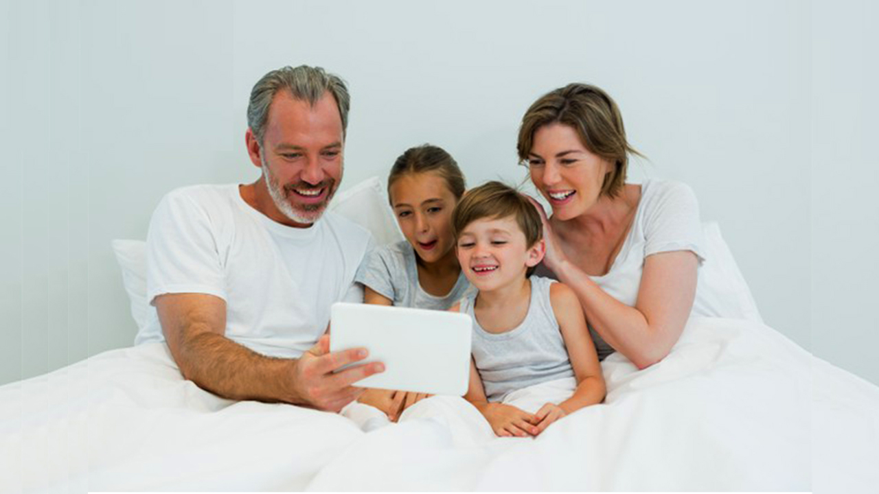 Happy family on bed